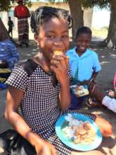 A student enjoying a sweet potato for lunch
