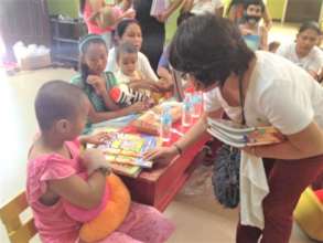 Children receive coloring books