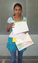 Pooja showing her award cetificates