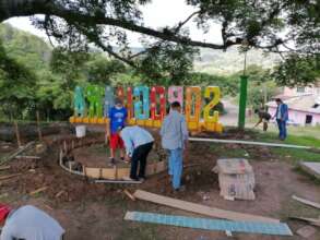Volunteers work on community plaza project