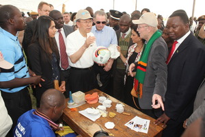 Ban Ki-Moon and Jacques Rogge inspect an A&K ball