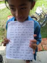 A sixth-grade student proudly shows her work