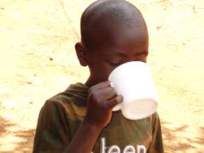 A child enjoying a cup of clean water.