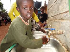 Children being taught how to clean their hands.