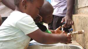 children washing their hands before meals