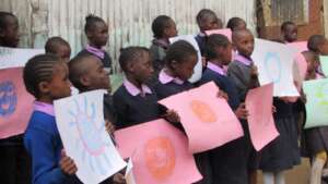 Children showing types of germs by drawing them