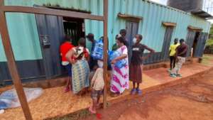 Women collecting water after demonstration and tra