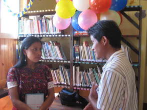 Librarian Raquel explains the library to a teacher