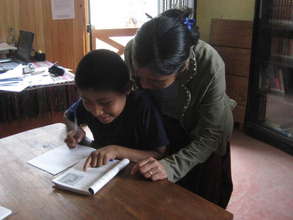 Librarian Raquel helps a student with his homework