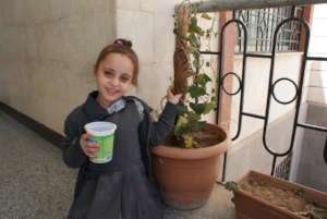 Sarah is happy with her seeds which inside the can