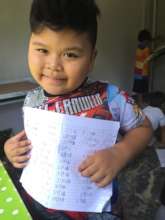 Thai boy excited to complete homework