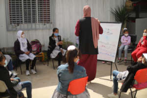 Science teacher, Ruwaida Amer, with her students