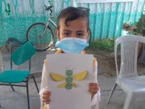 A child showing her art work