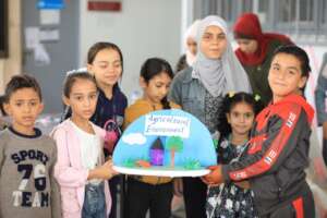 Children proudly showing their Science project