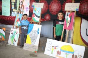 Children happily displaying their work