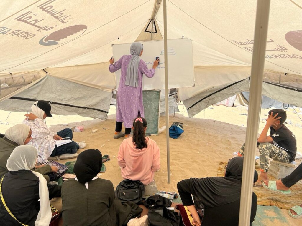 Teacher Ruwaida offering lessons in a tent