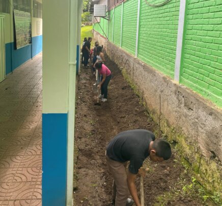 Students digging trench at STEM Center