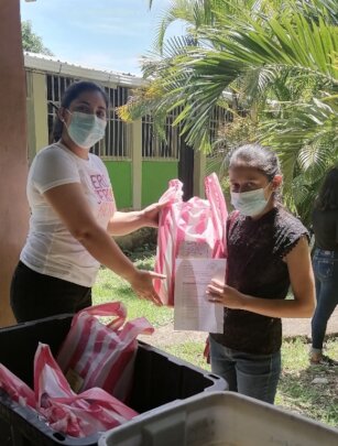 Nelly delivering materials to scholarship students