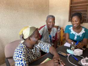 Dr. Ahongbonon, right, consulting with staff