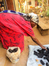 Older Woman Working on Briquettes