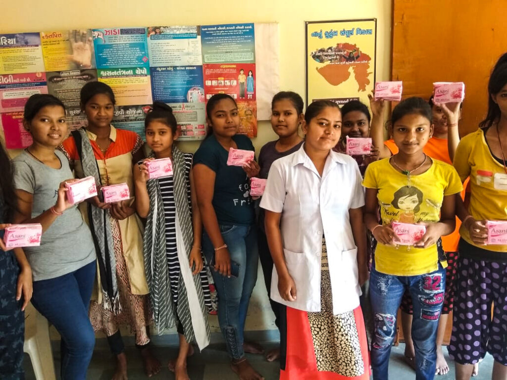 Young girls holding Asani Sanitary Napkins