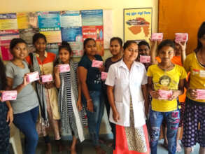 Young girls holding Asani Sanitary Napkins