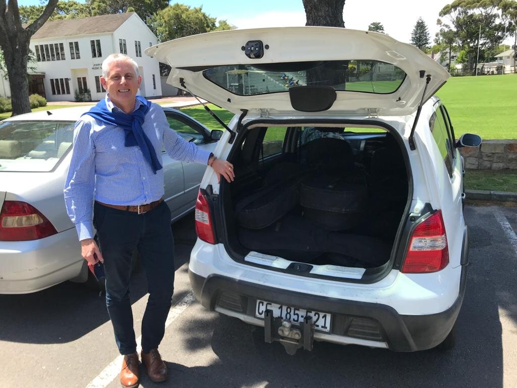 Mr Mitchell(Diocesan College) with donated guitars