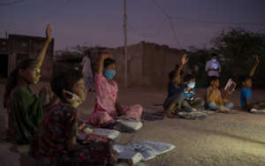 Children learn by the light of solar lanterns.