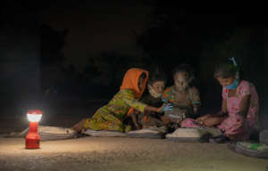 Girls read from a digital reader from  WorldReader