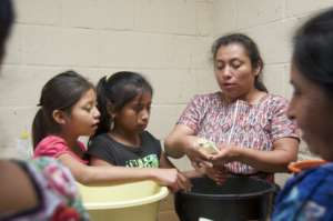 Sandy shows students how to stuff cabbage