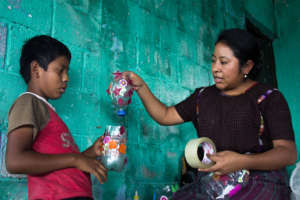 Students repurposing plastic bottles into crafts