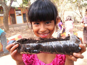 Student in La Cumbre showing off her plant