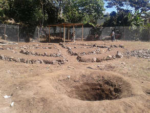 A rainwater collection well at the garden's base