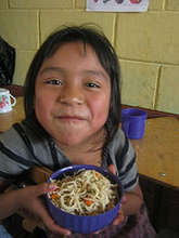 A student in Tzanchaj II enjoying her breakfast