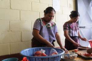 Mothers participate in a healthy cooking workshop
