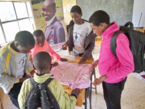 Chepsoo girls making Reusable Sanitary Kits