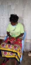 Participant making the menstruation braclet