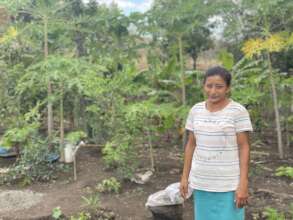 Sonia in front of her family garden