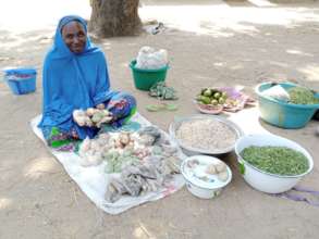 A beneficiary  at the Kodek village market