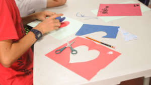 Children making paper heart art