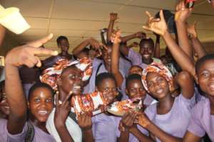 Female Student showcasing items they produced