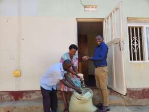 Kigongo hands Act4Africa 50 kgs of Grain