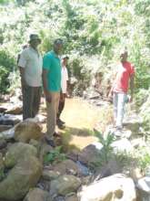Community members show the water spring