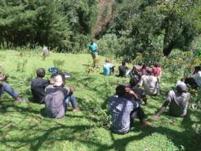 Staff member Shadrack speaks at community meeting