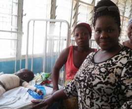 Director with burn child at the hospital