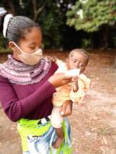 Mother feeding baby Ready to Use Therapeutic Food