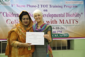 Fahmida receives her certificate from Dr Mel Adams