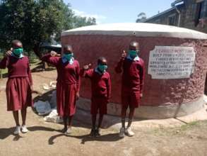 School children at Kedowa River Farm water tank