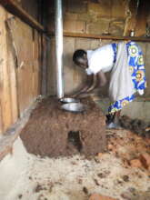 Anna installing a smokeless stove