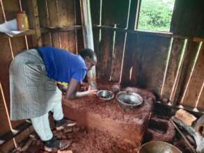 Gladys installing a smokeless stove for a family